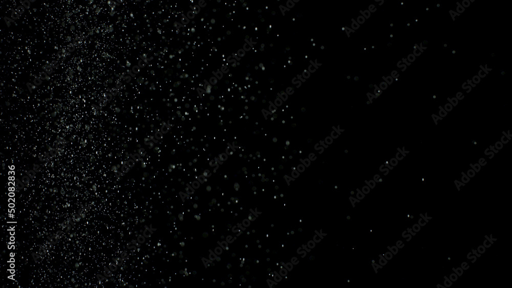 White dust debris exploading on black background, motion powder spray burst in dark texture. Stock footage. Beautiful small particles splashing and falling down.