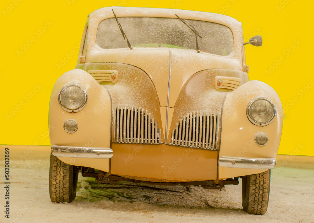 beige retro car on a yellow background
