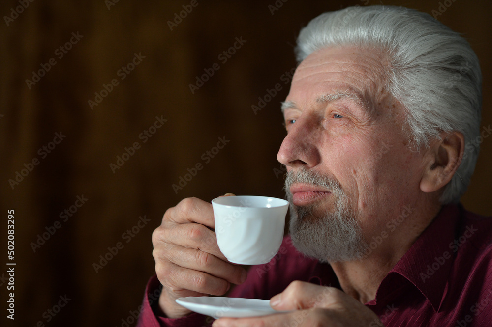 Close-up portrait of senior man drinking at home Close-up portrait of senior man drinking at home
