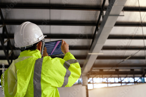 Fotografiet Construction Civil Engineer use technology software through tablets to scan buil