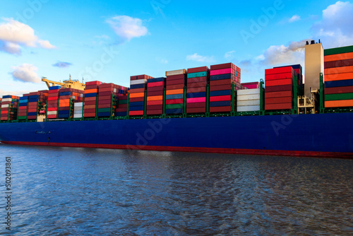 Huge cargo container ship sailing on the Elbe river, Hamburg, Germany