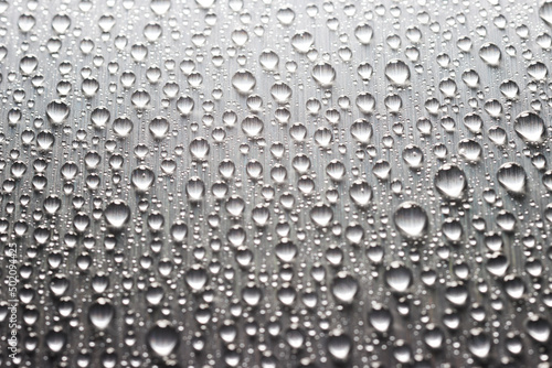 Gray flat metallic surface with drops of water. Abstract background of metal texture