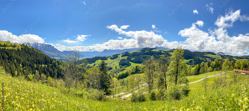View to Inntal and Wilder Kaiser mountain range in the Alps, Building land for new construction project on green sunny meadow, plot for construction area in early summer