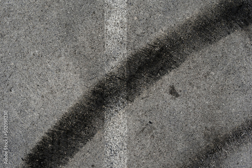 Wallpaper Mural Asphalt texture with white line and tire marks. Smooth asphalt road. Tarmac dark grey grainy road background.Top view Torontodigital.ca