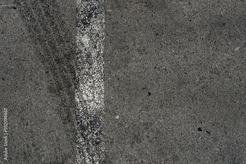 Wallpaper Mural Asphalt texture with white line and tire marks. Smooth asphalt road. Tarmac dark grey grainy road background.Top view Torontodigital.ca