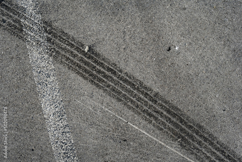 Wallpaper Mural Asphalt texture with white line and tire marks. Smooth asphalt road. Tarmac dark grey grainy road background.Top view Torontodigital.ca