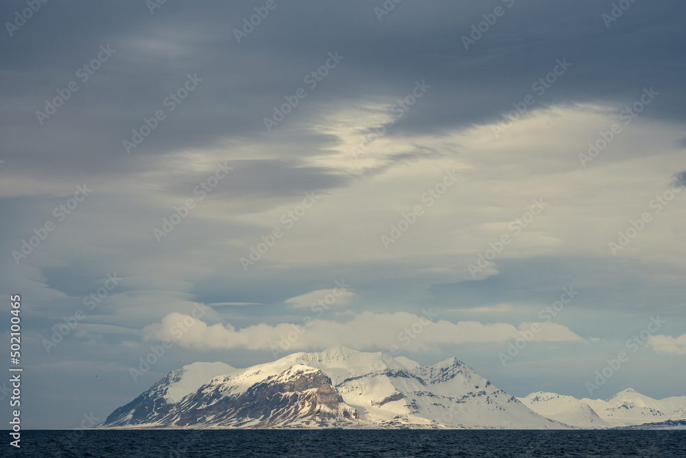 Panoramic view of Blue hour of the mountains, snow and Sea in Svalbard, Norway.