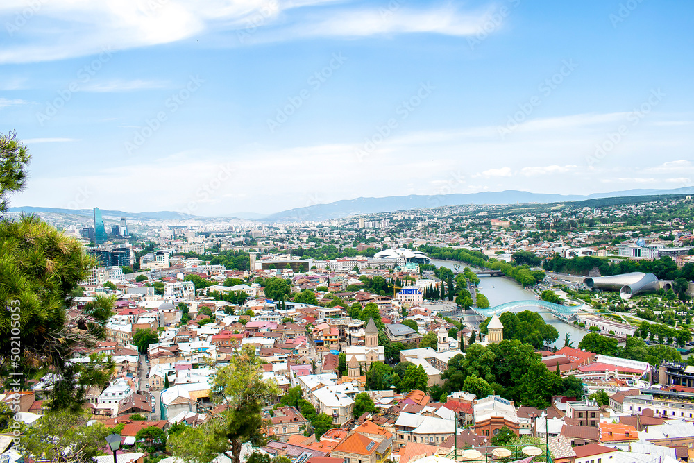 Scenic aerial beautiful view panorama of old historic city Tbilisi center, architecture buildings roofs, Georgia in summer sunny day, nature bright travel landscape
