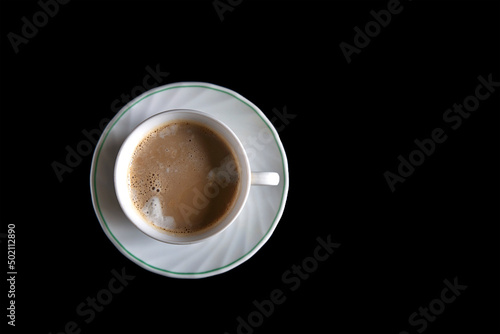 Top view of a cup of coffee isolated on black background. Top view with copy space switch concept. Get energy in the morning. Caffeine stimulates the brain.