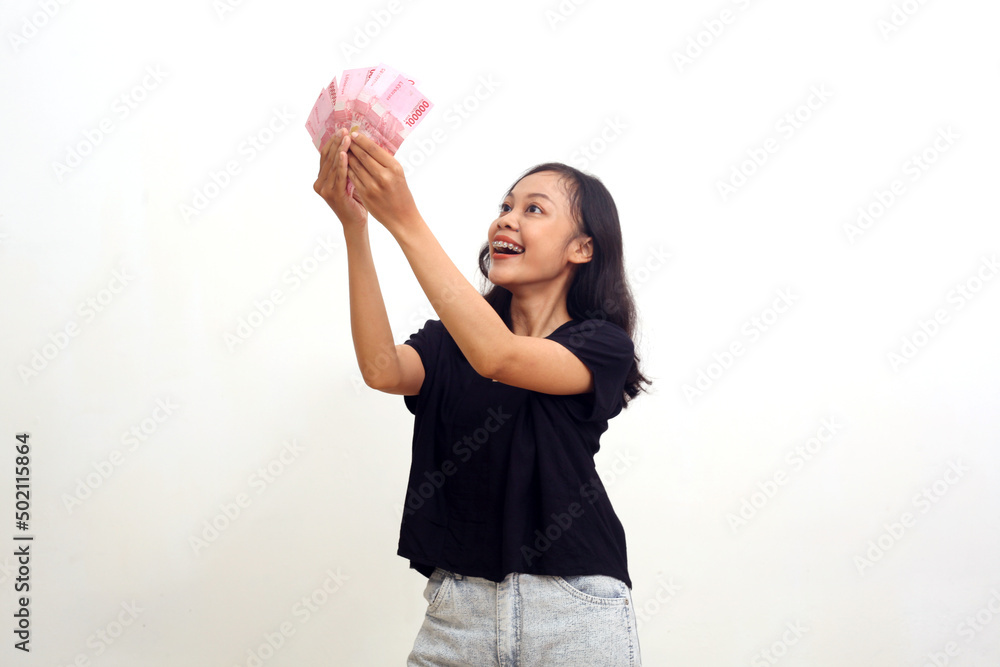 Excited Asian Young Woman Holding Money. Isolated on white background Excited Asian Young Woman Holding Money. Isolated on white background