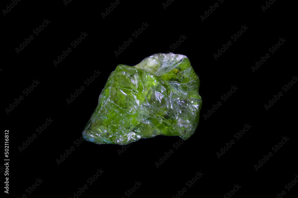 Raw green Peridot from Pakistan on black background. Weight 4.16 grams (20.8 carats). Photographed on black background. 
