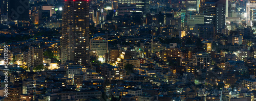 Urban landscape with dense buildings at central Tokyo area at night.