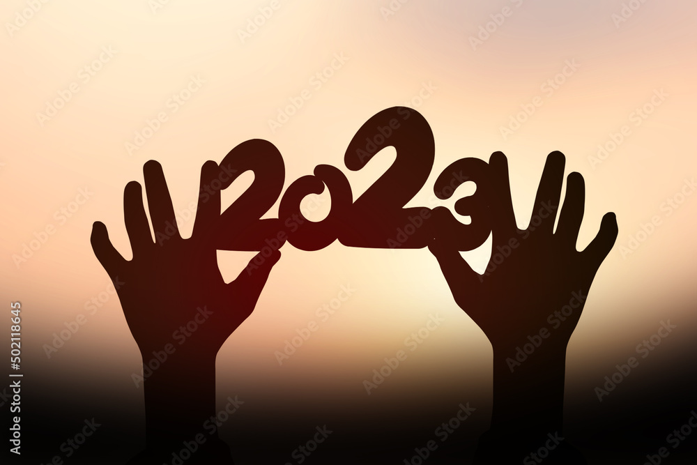 2023 silhouette on human hand. Happy new year concept.