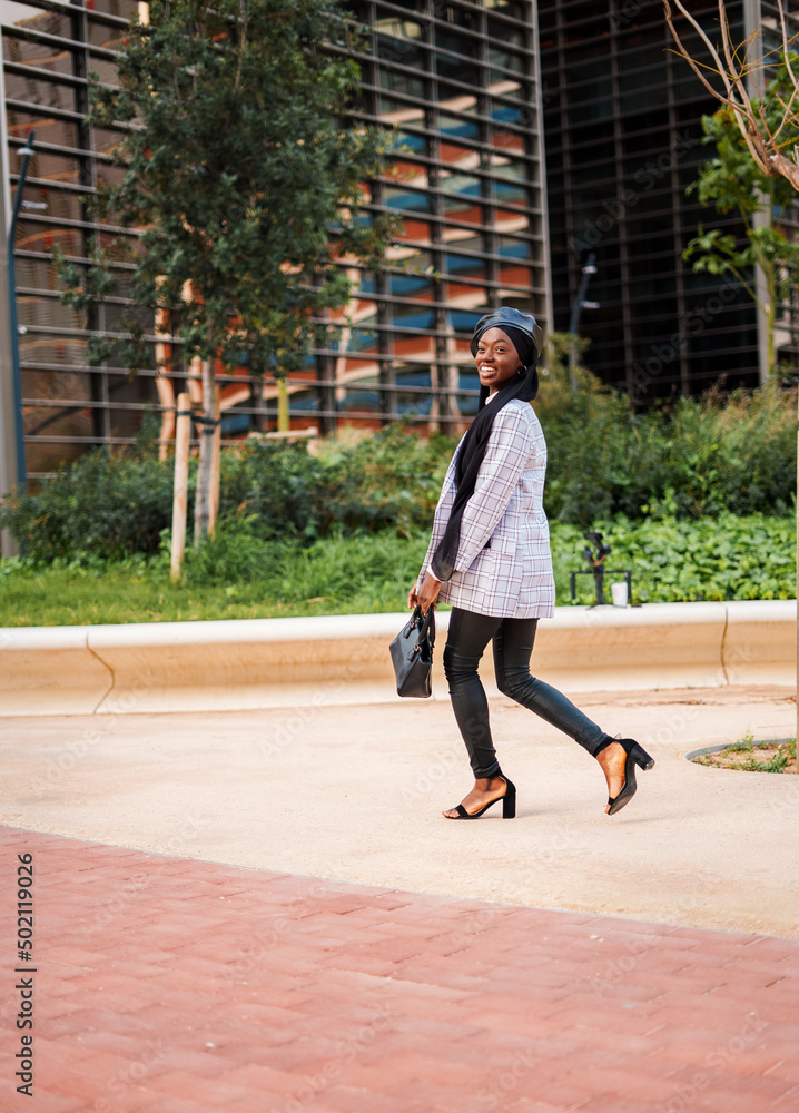 Stylish black woman enjoying pleasant walk in city park