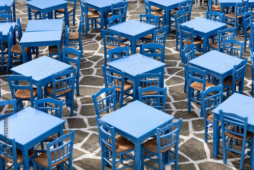 Blue tables and chairs of a taverna photo