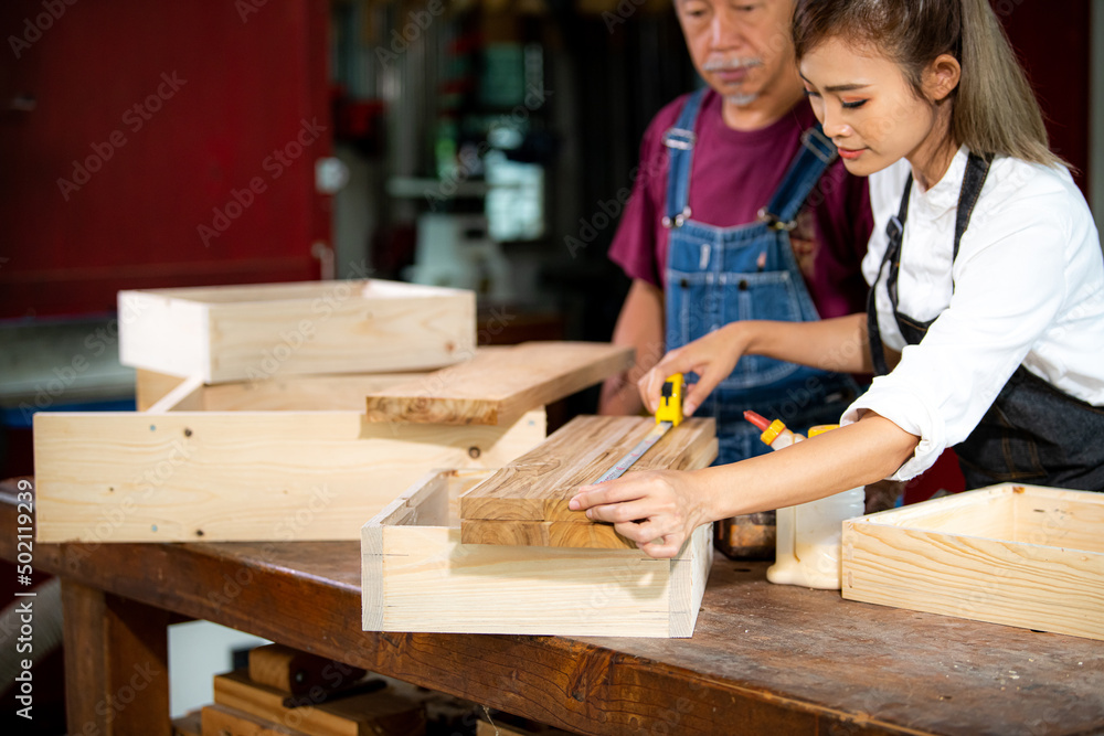 A carpenter uses equipment on a wooden table in a carpentry shop. woman working in a carpentry shop A carpenter uses equipment on a wooden table in a carpentry shop. woman working in a carpentry shop