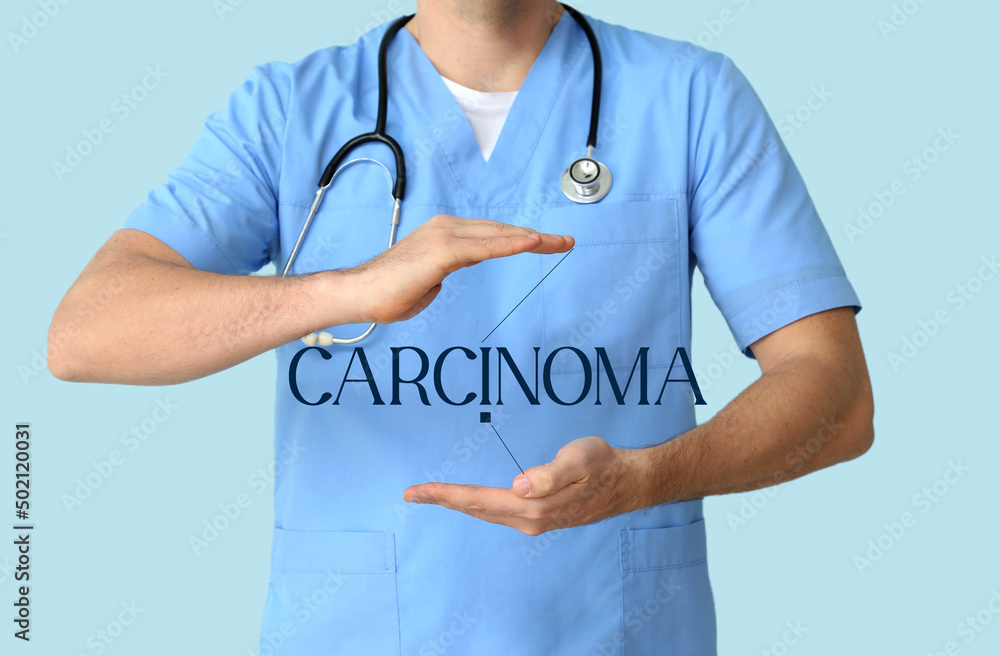 Male doctor with word CARCINOMA on virtual screen against blue background Male doctor with word CARCINOMA on virtual screen against blue background