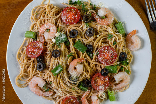 whole wheat spaghettitop with parmaesan cheese photo