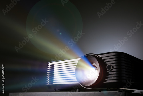 Modern video projector on black background photo