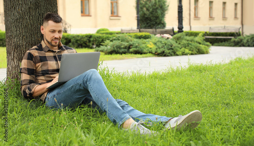 Handsome man with laptop re...