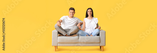 Young couple meditating on ...