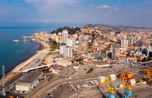 Aerial view of large seaport in Albanian city of Durres on coast of Adriatic Sea overlooking shipyard and c photo