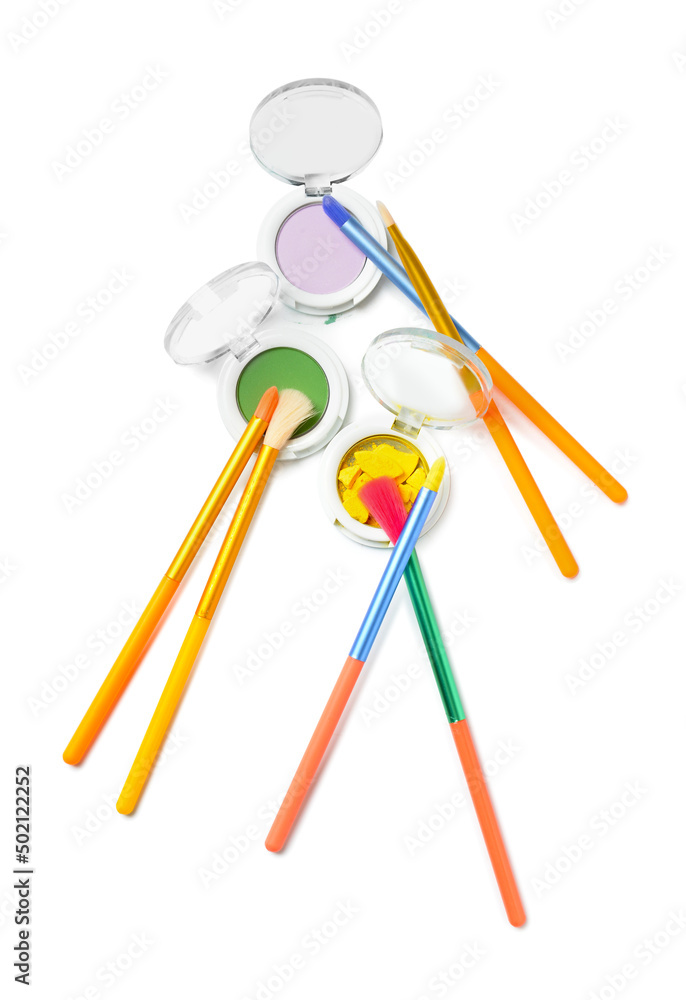 Colorful makeup brushes with eyeshadows on white background Colorful makeup brushes with eyeshadows on white background