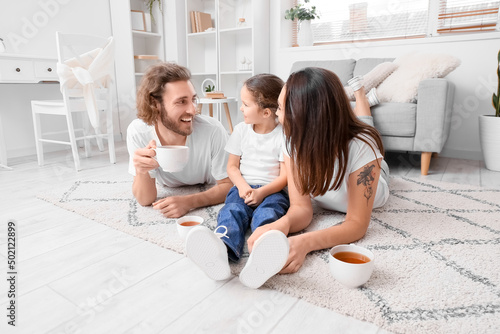 Young family with cups of t...
