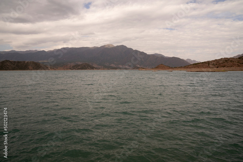Fototapeta Naklejka Na Ścianę i Meble -  View of the reservoir in Potrerillos, Mendoza. The arid environment, turquoise glacier water lake and Andes mountains in the background.