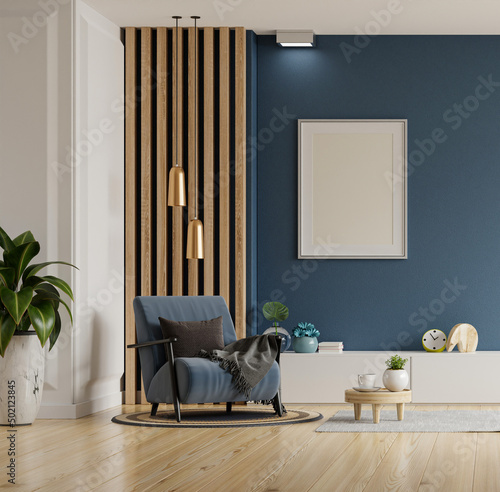 Poster mockup with vertical frames on empty dark blue wall in living room interior with blue velvet armchair.