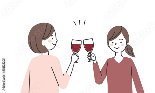 ワイングラスを手に乾杯をする女性2人
