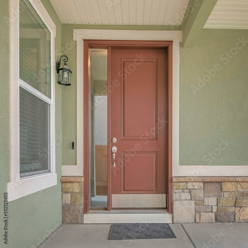 Square Brown front door with sidelight at the entrance of a house
