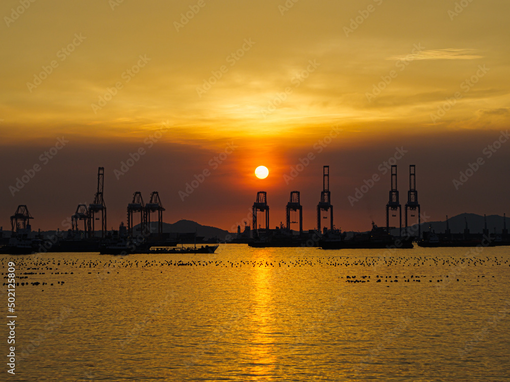 Container ship loading and unloading, Cargo freight ship for Online international order worldwide concept. Cargo containers ship. evening Sun
