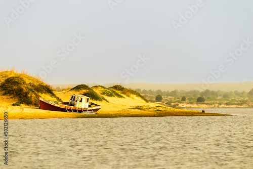 barco encalhado na beira da praia em Puta del Diablo Uruguay photo