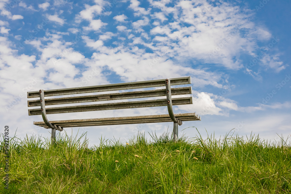 Empty bench in the blue sky background. Empty bench in the blue sky background.