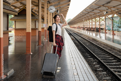 Asian woman backpacker traveler plan summer holiday after coronavirus. Empty tourists on train railway platforms. Use bus train sustainable environmental friendly transport