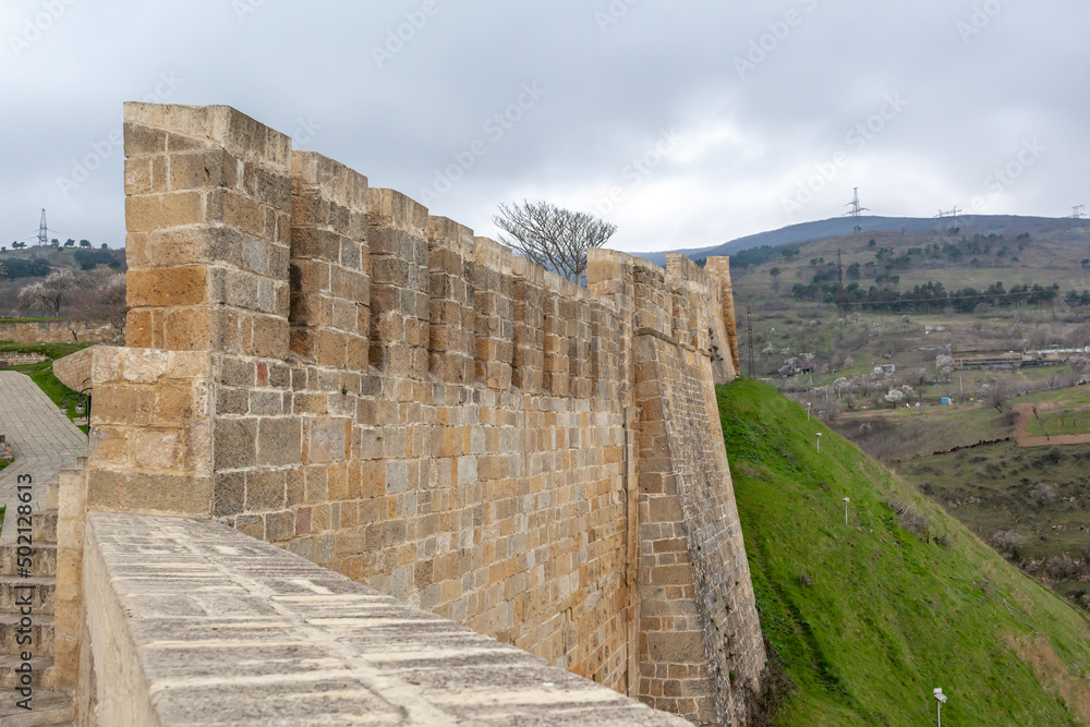 Derbent fortress Naryn Kala is the main touristic attraction in the city. Dagestan, North Caucasus, Russia. the city of Derbent in the distance, the blue sea and the sky.