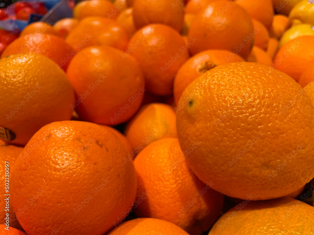 Retail produce piles of oranges on display