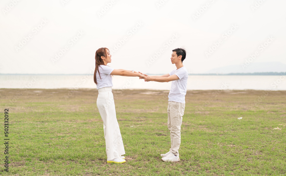 Happy young Asian couple in bride and groom t-shirt Happy young Asian couple in bride and groom t-shirt