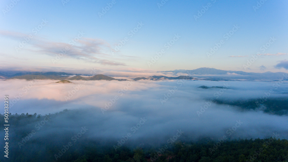 Sun view over the clouds with mountains and mist Blue sky,