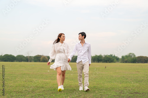 Happy young Asian couple in bride and groom clothing