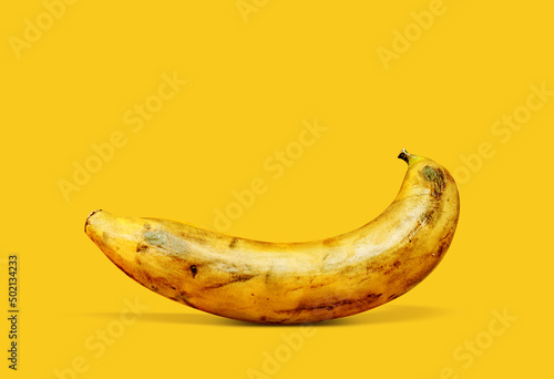 very ripe banana fruit on a yellow background