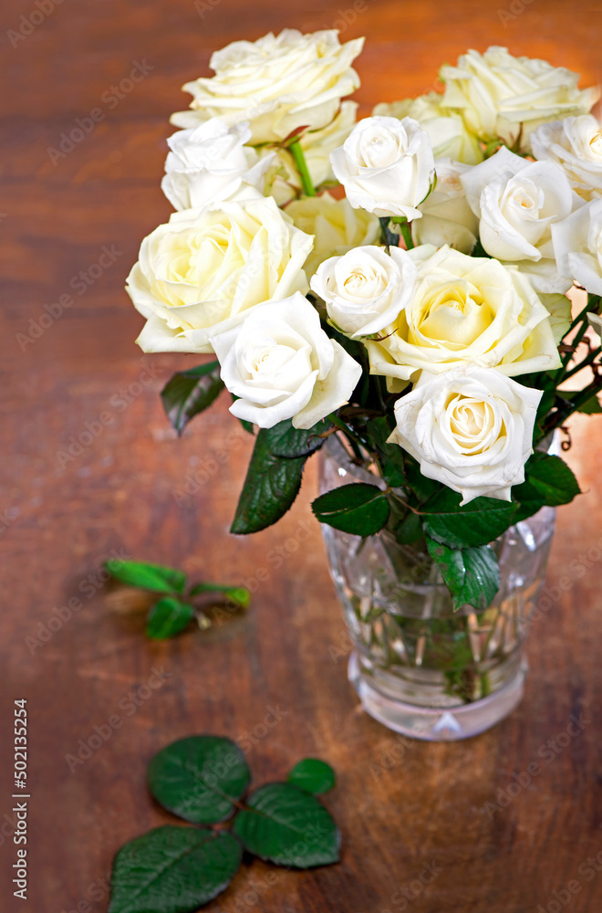 bouquet of blossoming roses in vase on a wooden background bouquet of blossoming roses in vase on a wooden background