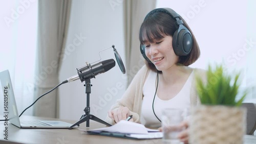 female presenters hosting audio online talk show, speak into microphone about news