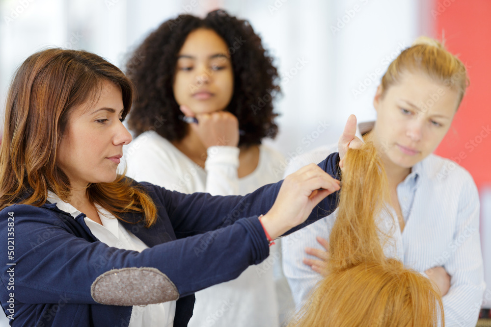 female hairdresser does educational hair on dummy female hairdresser does educational hair on dummy
