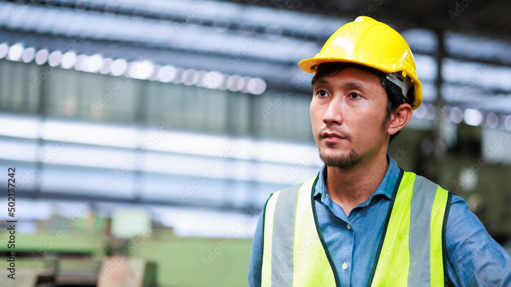 Metal machine in heavy Industry Manufacturing. Asian male factory worker wearing safety hard hat helmet control lathe machine to drill components. Metal machine in heavy Industry Manufacturing. Asian male factory worker wearing safety hard hat helmet control lathe machine to drill components.