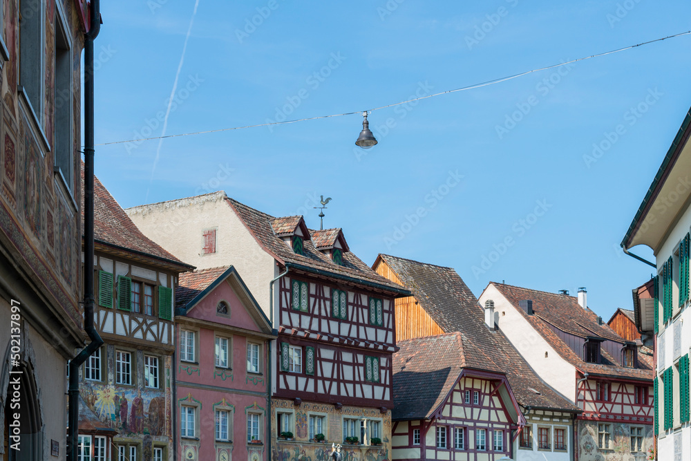 Historical tenement house (apartment building) with facade paintings and half timbered walls in an old town in Swiss city Stein am Rhein in Switzerland 

