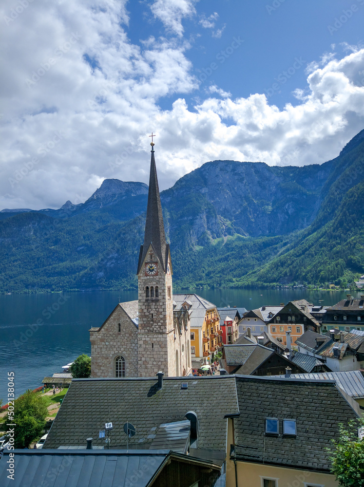 Beautiful view of the city of Hallstatt against the backdrop of the green Austrian Alps and the lake. Vertical. Salzkammergut region, Austria