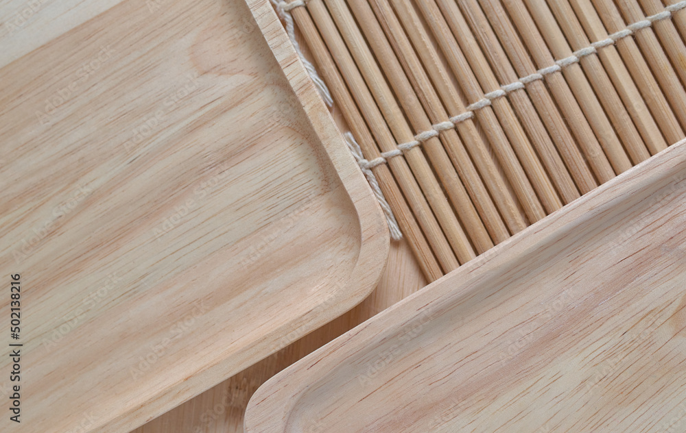 Background the wooden tray and bamboo cooking mat