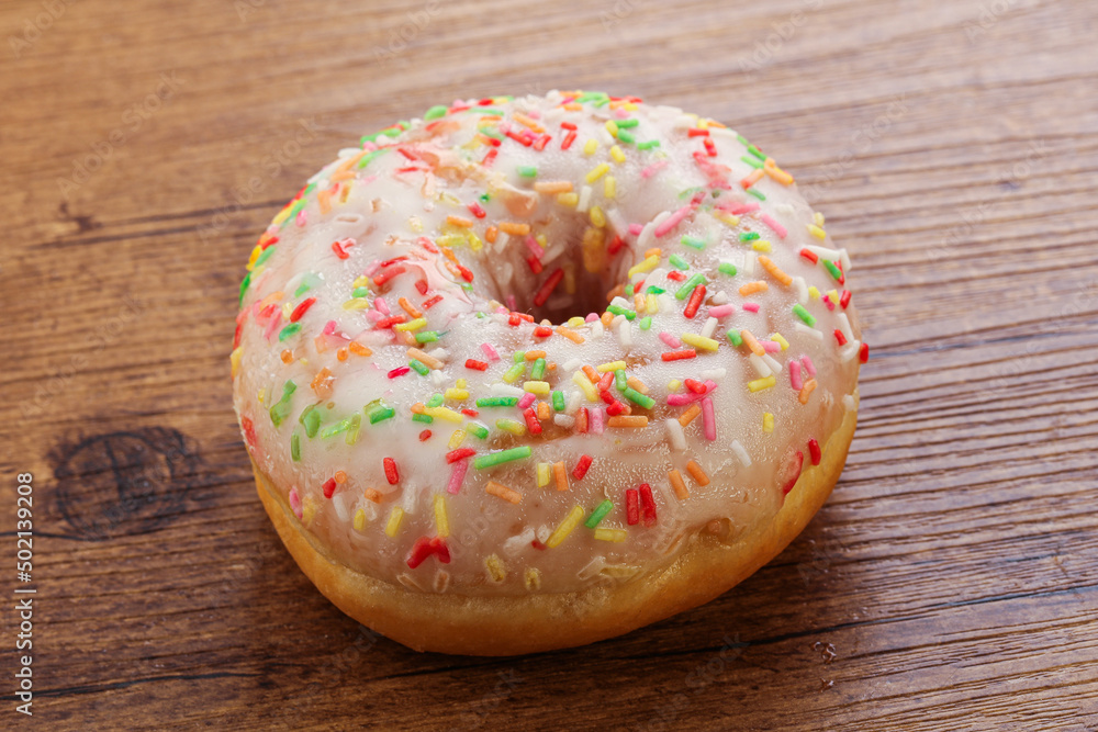 Sweet glazed vanilla donut with icing Sweet glazed vanilla donut with icing
